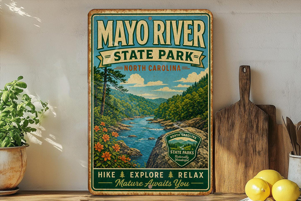 A vintage-style metal sign for Mayo River State Park in North Carolina, featuring a scenic illustration of the river surrounded by lush greenery and mountains.