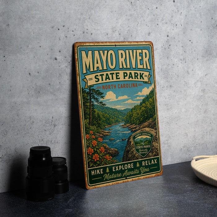 A vintage-style metal sign for Mayo River State Park in North Carolina, featuring a scenic illustration of the river and surrounding landscape.
