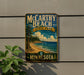 A vintage-style metal sign for McCarthy Beach State Park in Minnesota, featuring a scenic landscape with a beach, pine trees, and a lake.
