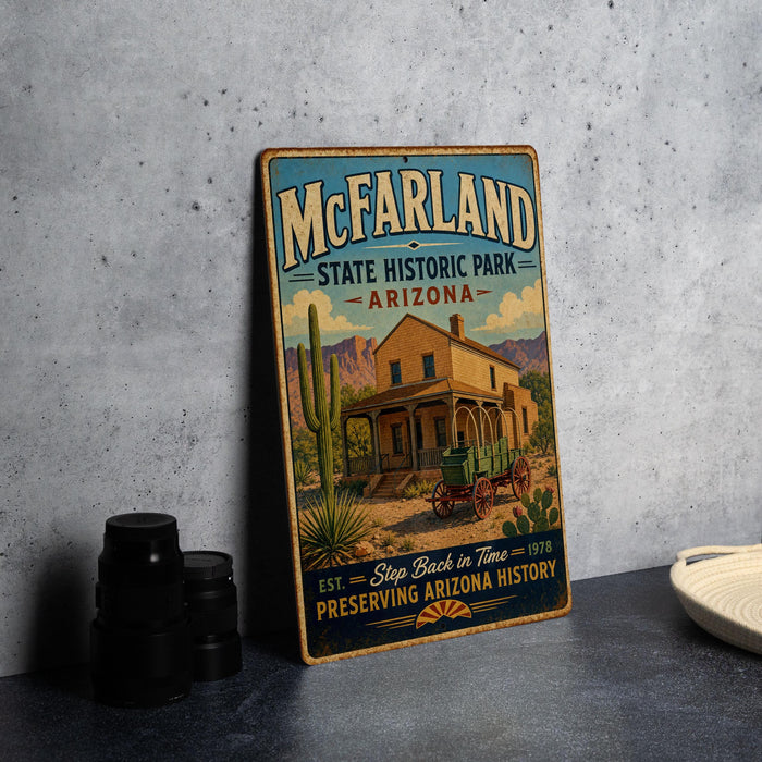 A vintage-style sign for McFarland State Historic Park in Arizona, featuring a desert scene with a house, wagon, and cactus.