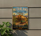 A vintage-style metal sign for McFarland State Historic Park in Arizona, featuring a desert landscape with a cactus and a horse-drawn carriage.