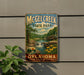 A vintage-style metal sign for McGhee Creek State Park in Oklahoma, featuring a scenic landscape with a waterfall and flowers.