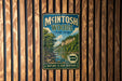 A vintage-style metal sign for Mcintosh Woods State Park in Iowa, featuring a scenic landscape with a river and forest.