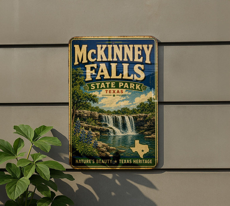 A vintage-style metal sign for McKinney Falls State Park in Texas, featuring a scenic illustration of the waterfall surrounded by lush greenery.