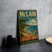 A vintage metal sign for Michigan State Park, featuring a scenic landscape with a beach, mountains, and a lake.