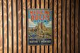 A vintage-style metal sign for Medicine Rocks State Park, featuring a scenic image of the park's rock formations and a mountain range.