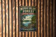 A vintage-style metal sign for Meeman-Shelby Forest State Park in Tennessee, featuring a scenic landscape with a lake and trees.