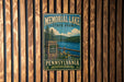 A vintage metal sign for Memorial Lake State Park in Pennsylvania, featuring a scenic image of the lake and surrounding landscape.