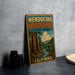 A vintage metal sign for Mendocino Woodlands State Park in California, featuring an illustration of a forest with tall trees and a river.