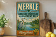 A vintage-style sign for the Merkle Natural Resources Management Area in Maryland, featuring an illustration of a bird and a river.