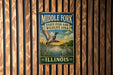A vintage metal sign for Middle Fork State Fish and Wildlife Area in Illinois, featuring a duck and a heron in a scenic landscape.