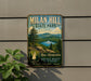 A vintage-style metal sign for Milan Hill State Park, featuring a scenic landscape with mountains, trees, and a lake.
