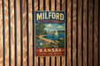 A vintage metal sign for Milford State Park in Kansas, featuring a scenic image of a lake with a sailboat and a lighthouse.