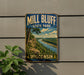 A vintage-style sign for Mill Bluff State Park in Wisconsin, featuring a scenic landscape with a river and forest.