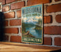 A vintage-style metal sign for Millersville State Park in Washington, featuring a mountain landscape and a river.
