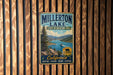 A vintage metal sign for Millerton Lake State Recreation Area, featuring a scenic image of the lake and mountains.