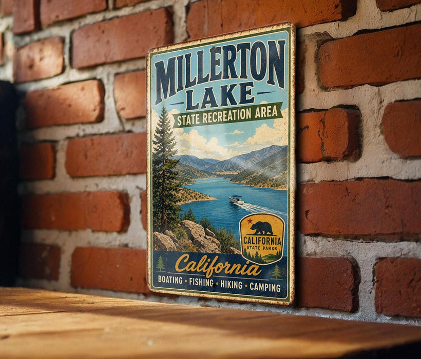 A vintage metal sign for Millerton Lake, California, featuring a scenic image of the lake surrounded by mountains and a boat on the water.