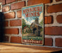 A vintage-style sign for the State Historic Site of Missouri Mills, featuring an illustration of a mining operation with a wooden building and a coal wagon.