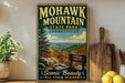 A vintage-style sign for Mohawk Mountain State Park in Connecticut, featuring a scenic mountain landscape with pine trees and a sign indicating the elevation of 1680 feet.