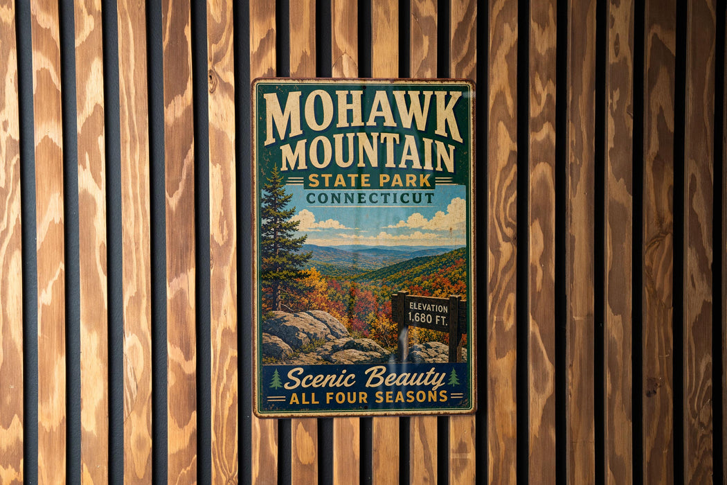 A vintage metal sign for Mohawk Mountain State Park in Connecticut, featuring a scenic mountain landscape with a sign indicating the elevation of 1,860 feet.