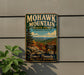 A vintage-style metal sign for Mohawk Mountain State Park in Connecticut, featuring a scenic mountain landscape and the text "Scenic Beauty All Four Seasons".