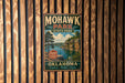 A vintage-style metal sign for Mohawk Park, Oklahoma, featuring a scenic landscape with a lake and mountains.