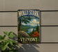 A vintage-style metal sign for Molly Stark State Park in Vermont, featuring a scenic landscape with a river, mountains, and autumn foliage.