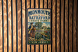 A vintage metal sign for Monmouth Battlefield State Park in New Jersey, featuring an illustration of a soldier on horseback and a cannon.