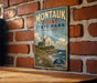 A vintage-style metal sign for Montauk Point State Park in New York, featuring a lighthouse and a coastal landscape.
