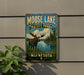 A metal sign with a moose and a lake, indicating the location of Moose Lake State Park in Minnesota.