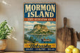 A vintage-style sign for Mormon Island, a state recreation area in Nebraska, featuring a scenic illustration of a lake and a mountain.