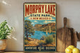 A vintage-style poster advertising Morphy Lake State Park in New Mexico, featuring a scenic landscape with a lake, mountains, and desert vegetation.