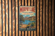 A vintage-style metal sign for Morphy Lake State Park in New Mexico, featuring a scenic landscape with a lake, mountains, and desert vegetation.