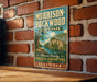 A vintage-style metal sign for the Morrison-Rockwood State Park in Illinois, featuring a scenic illustration of a river and forest landscape.