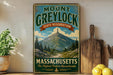 A vintage-style metal sign for Mount Greylock State Reserve in Massachusetts, featuring a mountain landscape and the text "The Highest Peak in Massachusetts".