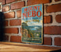 A vintage metal sign for Mount Nebo State Park in Arkansas, featuring a scenic landscape with a river and mountains.