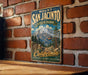 A vintage metal sign for Mount San Jacinto State Park in California, featuring a scenic mountain landscape with a ski lift.