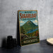 A vintage-style sign for Mount Sugarloaf State Reserve in Massachusetts, featuring a scenic mountain landscape with a lake and pine trees.