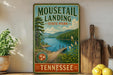 A vintage-style sign for Moutail Landing State Park in Tennessee, featuring a scenic landscape with a lake, mountains, and a bridge.