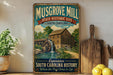 A vintage-style metal sign for Musgrove Mill, a historic site in South Carolina, featuring a wooden mill with a waterfall and a bridge.