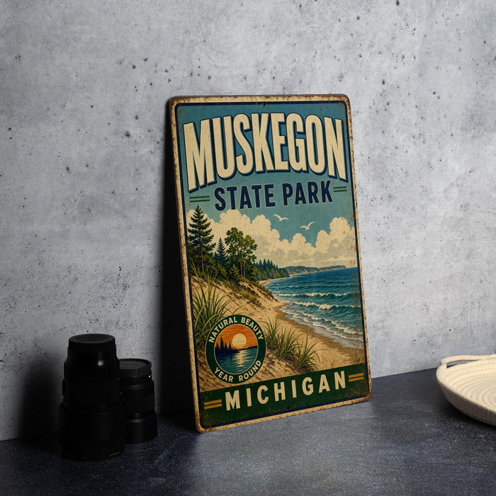 A vintage-style metal sign for Muskegon State Park, featuring a scenic landscape with a beach, mountains, and a lake.