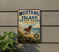 A vintage-style metal sign for Mustang Island State Park in Texas, featuring a horse running on a beach with a blue sky and ocean in the background.
