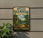 A vintage-style metal sign for Myles Standish State Forest in Massachusetts, featuring a scenic landscape with pine trees and a lake.
