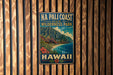 A vintage-style metal sign for Na Pali Coast State Wilderness Park in Hawaii, featuring a mountainous landscape with a beach and ocean.