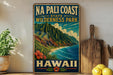 A vintage-style metal sign for the Na Pali Coast State Wilderness Park in Hawaii, featuring a mountainous landscape with a beach and ocean.