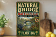 A vintage-style sign for Natural Bridge Battlefield Historic State Park in Florida, featuring an illustration of soldiers and a bridge.