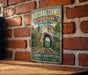 A vintage-style metal sign for the Natural Tunnel State Park in Virginia, featuring a scenic image of a tunnel surrounded by lush greenery and a wooden bridge.