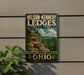 A vintage-style metal sign for Nelson-Kennedy Ledge State Park in Ohio, featuring a scenic landscape with a cliff and trees.