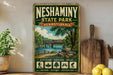 A vintage-style metal sign for Neshaminy State Park in Pennsylvania, featuring a scenic illustration of a bridge over a river surrounded by trees and greenery.