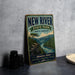 A vintage-style metal sign for New River State Park in North Carolina, featuring a scenic illustration of a river and mountains.